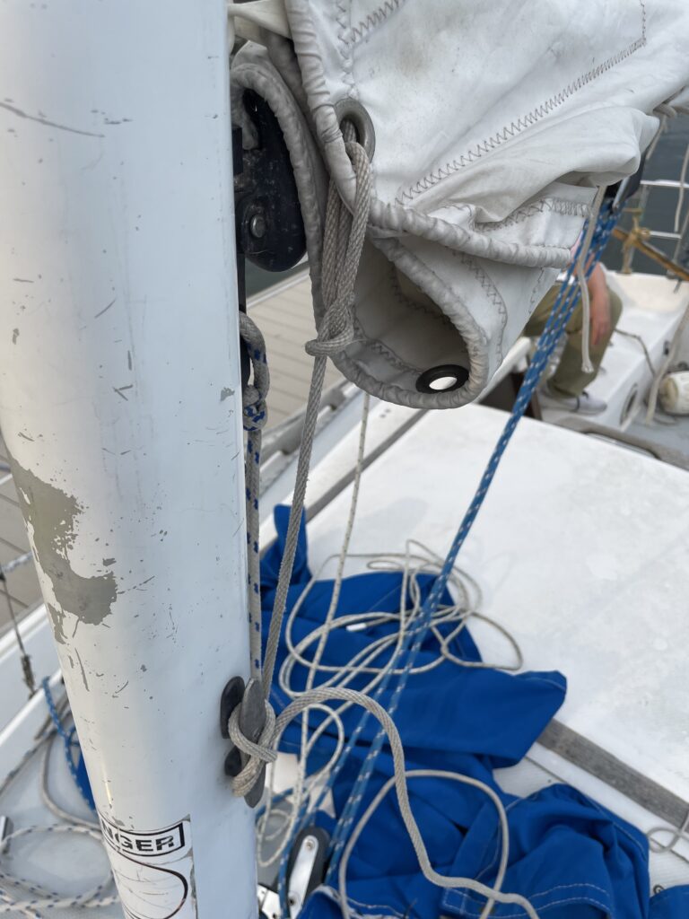 reefing line in the front of the sail cleated to the mast