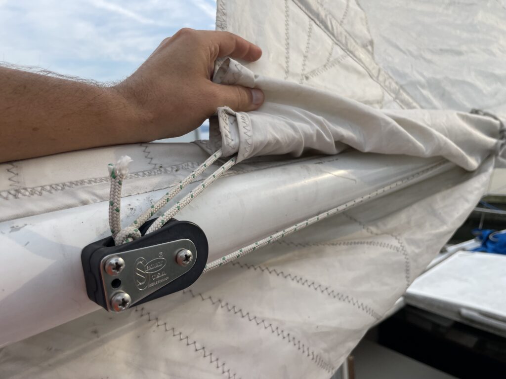 reefing line coming off the rear of the sail and through the block